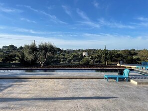 View from front of house over pool and beyond to olive groves
