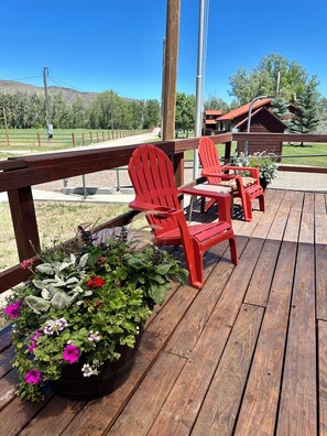 The wide porch on the Bunk House has ample room to enjoy the view.