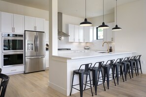 Huge Fully Stocked Chefs Kitchen With Bar Seating