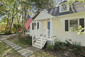 Welcoming exterior showcasing a screened porch, great for outdoor enjoyment.