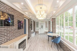 The main house’s sunroom is ideal for enjoying morning coffee or a book