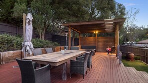 Alfresco area with outdoor table and undercover seating area. 