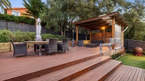 Alfresco area with outdoor table and undercover seating area. 