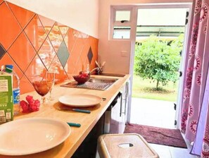 Kitchen with dishes, cooking equipments. Stove and a fridge