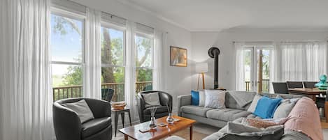 Living Room - Large sectional with two additional chairs and marsh views