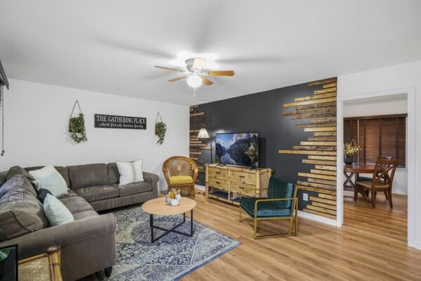 The open layout connects the living room to the adjacent dining area.