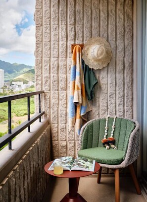 Enjoy peaceful moments on the balcony, where serene views and fresh air offer a tranquil setting for relaxation.