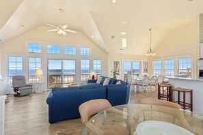 Relax in the spacious Living Area with cathedral ceilings and a flat-screen TV that is perfect for family movie night or catching up on your favorite shows after a day at the beach.