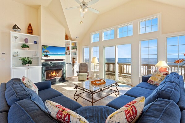 Relax in the spacious Living Area with cathedral ceilings and a flat-screen TV that is perfect for family movie night or catching up on your favorite shows after a day at the beach.