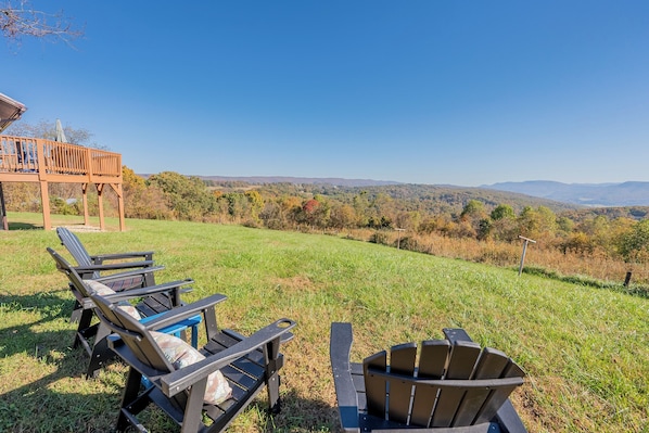 Relax and unwind in this idyllic outdoor setting at Valley View Getaway. Two comfortable Adirondack chairs face the breathtaking views of the lush Ellett Valley, inviting you to enjoy your morning coffee or an evening drink while soaking in the natural beauty. The perfect spot to catch up with loved ones or simply bask in the serene surroundings. This peaceful retreat is your g...