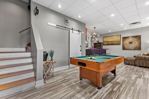 First Floor | Offers a pool table, bar area with TV, full bathroom and staircase.