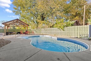 Backyard | Lovely pool area offers a gazebo with ample seating + BBQ.