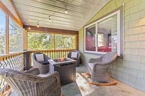 Second Floor | Screened patio + firepit, and rocking chairs.