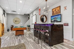 First floor | Bar area + tv,  and pool table.