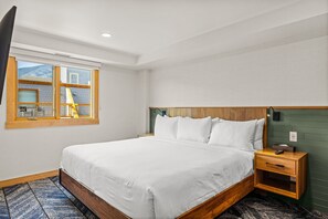 Bright, modern bedroom with large windows and a comfortable bed for a restful stay.