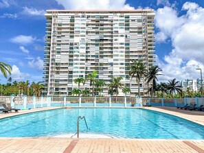 Enjoy a refreshing dip in the large pool after a fun day at the beach!