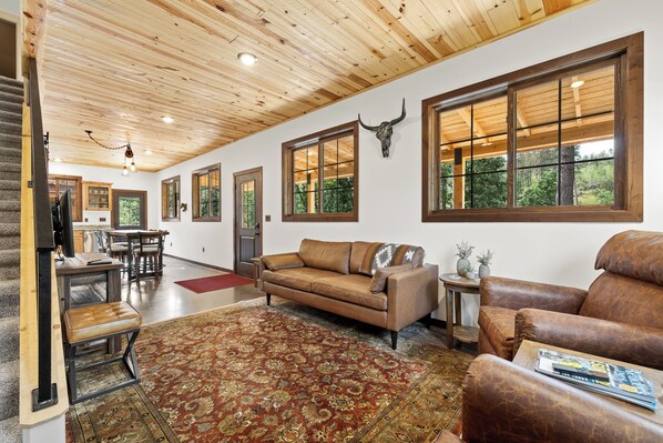 Living room with stairs leading to the loft/office and second bedroom. 