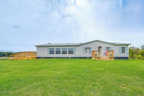 Property Exterior | Spacious Yard | Furnished Deck & Porch