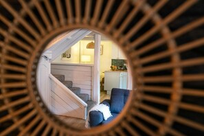 Mirror with reflection of staircase and lounge