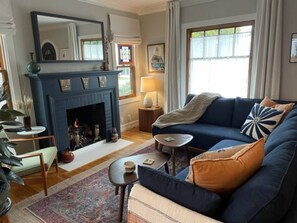 Another view of the living room with fireplace and hidden tv behind the mirror