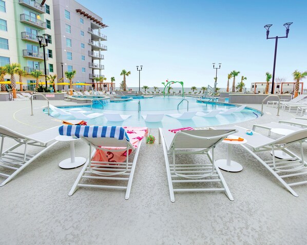 Relax by the oceanfront pool at Myrtle Beach Oceanfront Resort, enjoying stunning beach views.