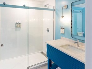 Walk-in shower with a sleek glass enclosure and contemporary finishes for a refreshing experience.
