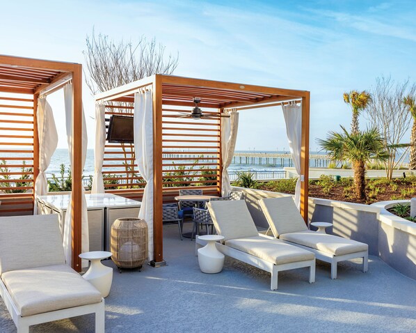Unwind in shaded poolside cabanas, offering a relaxing escape right by the water.