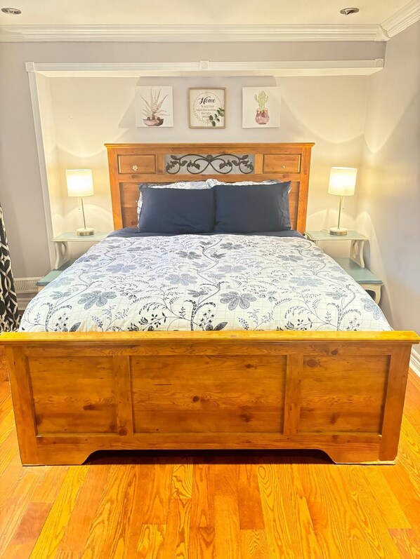 Queen Bed, phone chargers on the side table.
