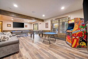 No Boredom Allowed in the 1st Floor Game Room with Smart TV in the Lounge, a Pool Table, Foosball, Poker Table and Multicade Arcade Game.