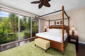 The large primary bedroom features a king-size bed, smart TV, and a private en suite bathroom with a soaking tub and walk-in shower.