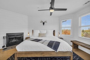 Bedroom 4: Master bedroom, king bed, 55” Smart TV w/cable, wood-burning fireplace, en-suite bath, access to balcony, upper floor
