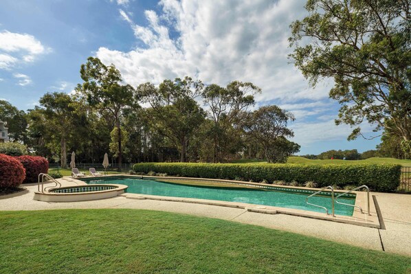 Dive into the shared outdoor pool or soak in the spa, all set among peaceful greenery right beside the golf course.