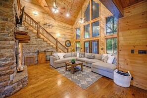 Comfortable and cozy living room with a TV and plenty of natural lighting perfect for gatherings!