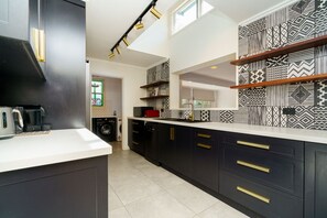 Our stylish kitchen boasts top-of-the-line amenities, making it easy to whip up your favorite meals and enjoy your stay.