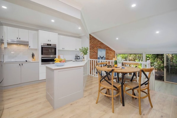 The dining area, adjacent to the kitchen, provides a cosy setting for family meals.
