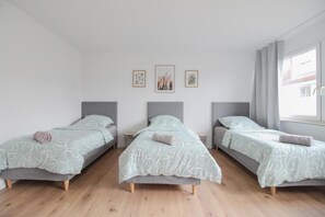 Bedroom 3 | 3 comfortable single beds with wardrobe (1)