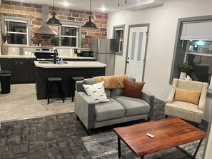 The open living room connected to kitchen to entertain family or relax.