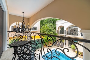 Relax on the balcony and take in the refreshing sights of the pool below