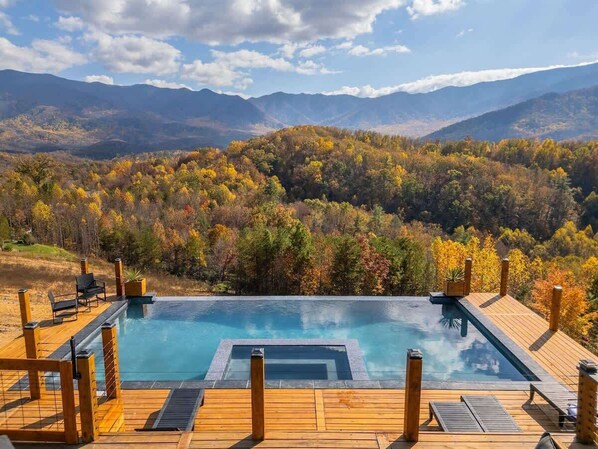 Experience breathtaking mountain views with this luxurious infinity pool and hot tub. Perfect for relaxing and enjoying nature's beauty!