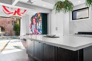 The modern kitchen is equipped with sleek appliances, ample bench space and a stylish breakfast bar for easy meals at home.
