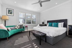 Unwind in the elegant primary bedroom, featuring a plush king bed and an abundance of natural light to greet you in the mornings.
