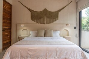 Serene king bedroom w/ soft tones & boho macramé décor