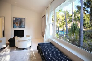 Master bedroom with garden and pool views. 