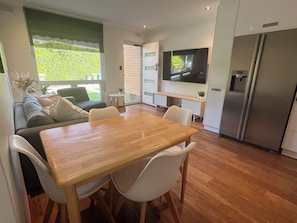 TrooBloo Glenelg North Unit | Dining table looking over seating area