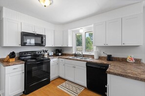Spacious kitchen equipped with basic cooking essentials