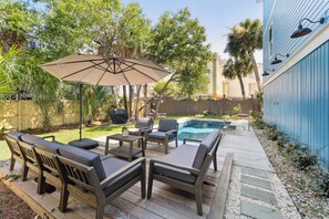 Private backyard paradise with a pool and lounge space.