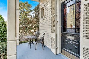Step through the grand French doors and onto a porch that tells stories of old New Orleans.