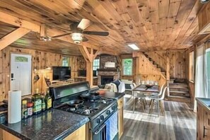 Kitchen is fully stocked with gas stove, spices, oils, plates, bowls, cups, and all utensils.