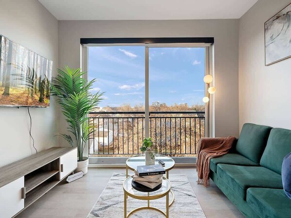 Modern oasis with stunning views, cozy velvet sofa, and chic decor. Relax & unwind!