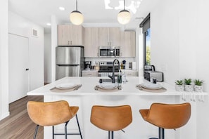 Fully stocked kitchen and dining area with modern appliances and everything you need to cook and enjoy meals at home